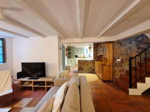 a living room with a couch and a tv at Casa da Água Formosa in Vila de Rei