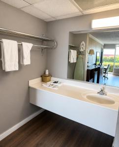 a bathroom with a sink and a large mirror at Hospitality House Union City I 69 US 51, TN in Union City +31 photos