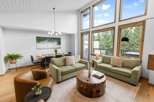 a living room with two couches and a table at Spring Creek Vacations in Canmore