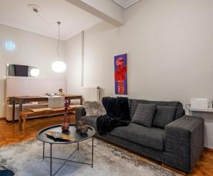 a living room with a couch and a table at 4 Travelers in Thessaloniki