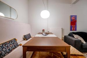 a living room with a wooden table and a couch at 4 Travelers in Thessaloniki +36 photos
