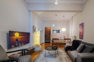a living room with a couch and a table at 4 Travelers in Thessaloniki