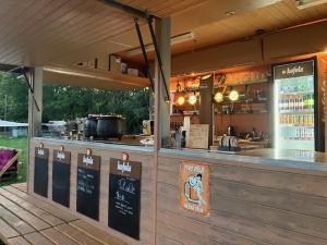 a restaurant with a counter with a bar and a grill at Jurty v Sadu in Český Brod +70 photos