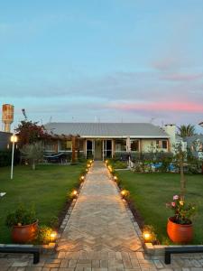 a pathway leading to a house with lights at Casa Bioma da Chapada in Chapada dos Guimarães