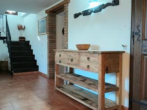 a wooden table in a room with a staircase at Casa Iriai in Dorgali