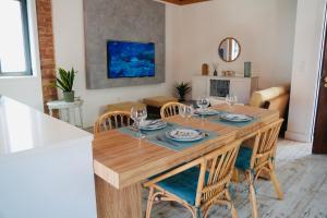 a dining room with a wooden table and chairs at Loft beach in Vieira de Leiria