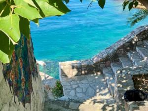 a view of the ocean from the stairs of a house at Albania Glamping in Himare