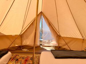 a room with a tent with a view of the ocean at Albania Glamping in Himare