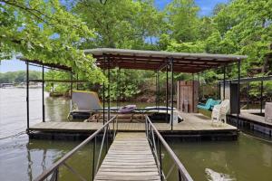 a pavilion on a dock on a body of water at Private Dock, Boat Launch, Fire Pit & Lake Views in Sunrise Beach