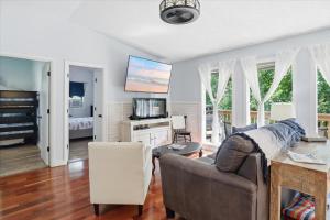 a living room with a couch and a television at Private Dock, Boat Launch, Fire Pit & Lake Views in Sunrise Beach