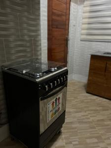 a black stove in a kitchen with a floor at Vn mbeya apartment in Mbeya