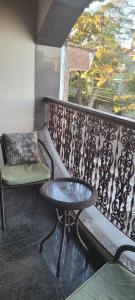 a table and a bench on a balcony at Hotel Alvorada do Sol in São Paulo