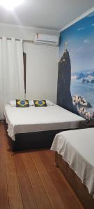 a bedroom with a bed with a view of a mountain at Hotel Alvorada do Sol in São Paulo