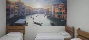 a painting of a canal with a gondola at Hotel Alvorada do Sol in São Paulo