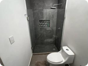 ein Badezimmer mit Dusche, Toilette und Waschbecken in der Unterkunft Habitación en Iker's House in Mérida