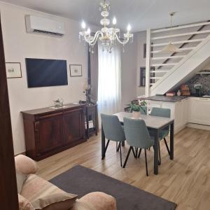 a living room with a table and chairs and a television at Casa Sant'Antonio Dimora Storica in Tarquinia