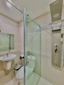 a bathroom with a shower and a toilet and a sink at Hila Hotel Vạn Ninh in Vạn Ninh +25 photos