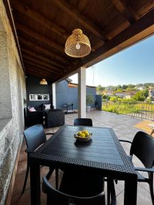a table with a bowl of fruit on a patio at Caneliña in Ourense