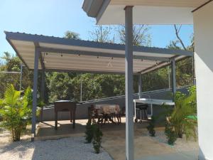 a pergola on a patio with a table at Cacique Room 2 in Playa Hermosa