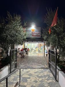 a entrance to a restaurant at night at Apartmani ,,Merlin,, in Utjeha