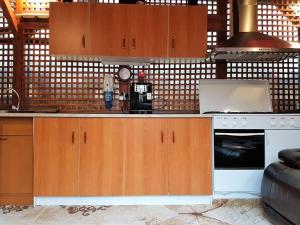 a kitchen with wooden cabinets and a counter top at Casa Stefania in Eforie Nord