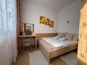 a bedroom with a bed and a table and a mirror at Natural Mielno in Mielno +22 photos
