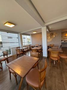 a dining room with wooden tables and chairs at Hotel Cabana in Parauapebas +54 photos