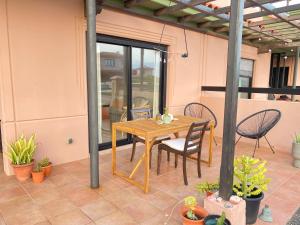 a wooden table and chairs on a patio at Mi Casa in Majanicho