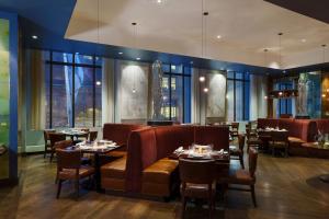 a restaurant with tables and chairs and windows at JW Marriott Chicago in Chicago