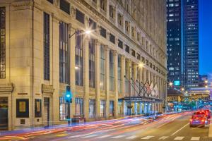 a building on a street with cars driving past it at JW Marriott Chicago in Chicago