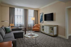 a living room with a couch and a tv at JW Marriott Chicago in Chicago