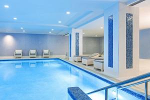 a swimming pool in a hotel with chairs and a couch at JW Marriott Chicago in Chicago