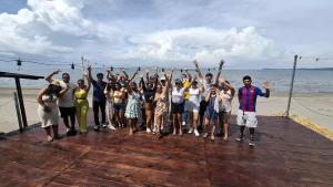 a group of people standing on a pier with their hands in the air at exotic island ometepe in Altagracia