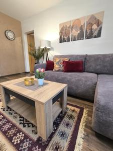 a living room with a couch and a coffee table at Vukašinova stanica in Pale