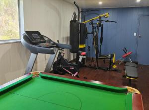 a room with a pool table and a gym at Gorge Castle in forest landscape in Galston