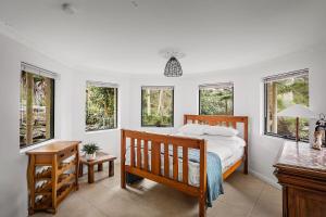 a bedroom with a bed and a desk and windows at Gorge Castle in forest landscape in Galston