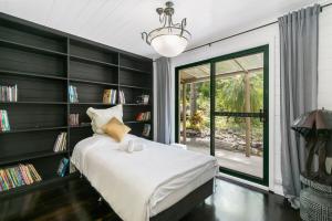 a bedroom with a bed and a book shelf at Gorge Castle in forest landscape in Galston +32 photos