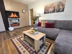 a living room with a couch and a coffee table at Vukašinova stanica in Pale
