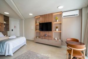 a bedroom with a bed and a flat screen tv at Studio in Condo with Pool and Gym MSU0906 in Governador Valadares