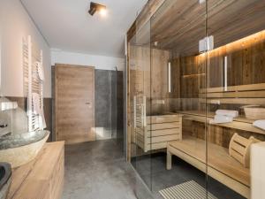 a bathroom with a glass shower and a sink at Donnersbach Lodge in Donnersbachwald +48 photos