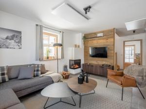 a living room with a couch and a fireplace at Donnersbach Lodge in Donnersbachwald