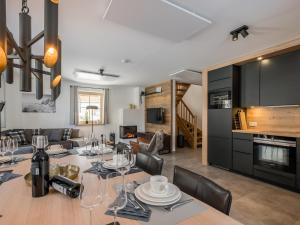 a dining room and living room with a table and chairs at Donnersbach Lodge in Donnersbachwald