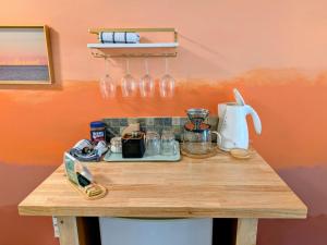 a kitchen counter with a table with a blender and wine glasses at Evergreen Bed & Breakfast in Hope