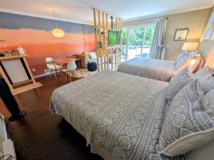a bedroom with two beds and a living room with a table at Evergreen Bed & Breakfast in Hope