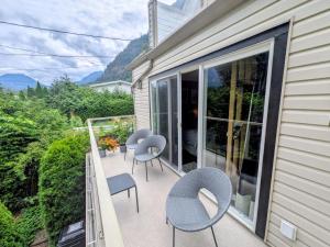 a balcony with chairs and tables on a house at Evergreen Bed & Breakfast in Hope