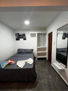 a bedroom with a bed and a flat screen tv at Apart Hotel miwi in Los Patios