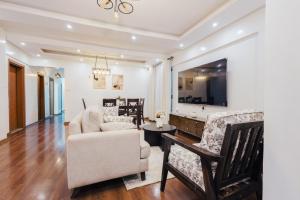 a living room with a couch and a chair at Rolling in Nairobi