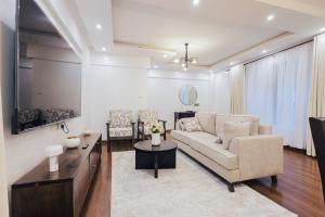a living room with a couch and a table at Rolling in Nairobi +7 photos