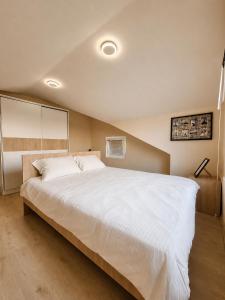 a bedroom with a large bed with white sheets at Villa Risteski Ohrid in Ohrid