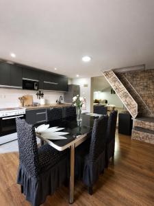 a kitchen and dining room with a table and chairs at Villa Risteski Ohrid in Ohrid